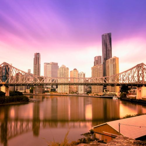 Brisbane sunset behind the cities skyline | Featured image for the Investment Property Buyers Agent Brisbane page from Setlr.